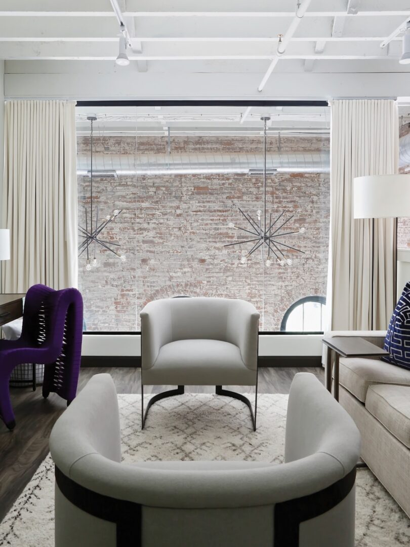 a living room filled with furniture and a large window