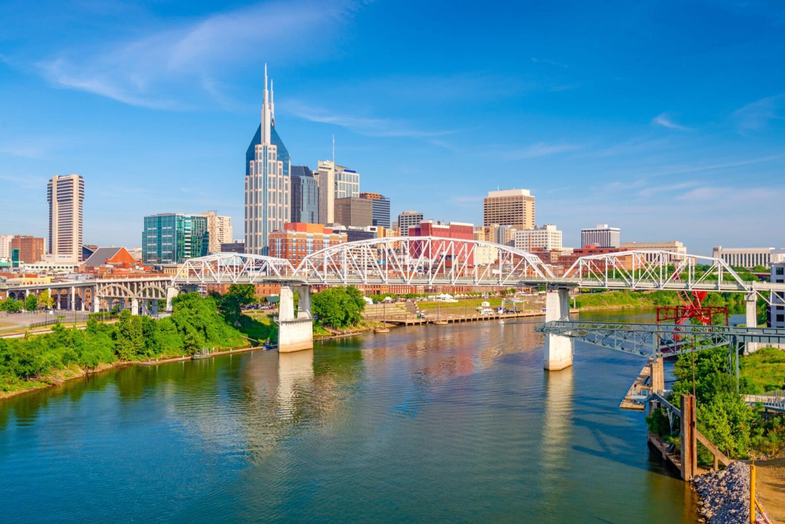a small boat in a body of water with Nashville in the background